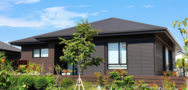 A high-resolution image showcasing a rich chocolate brown house with modern siding, 