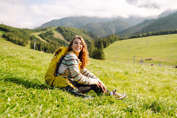 Woman tourist admiring the landscape mountains nature. Tourist traveler on background valley. Hiker...