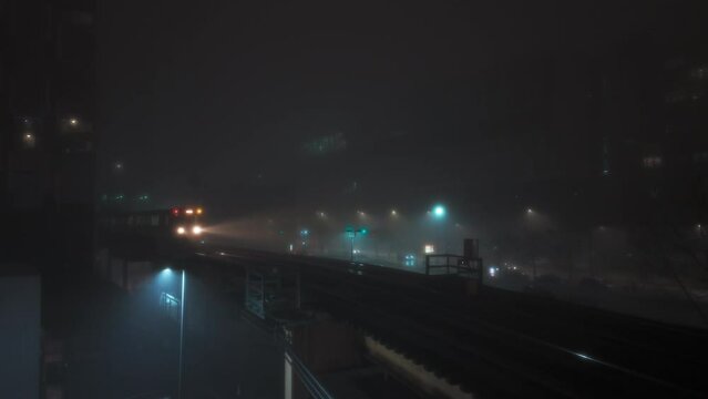 Train passing on Elevated Track at fogy Night. Subway in downtown Chicago