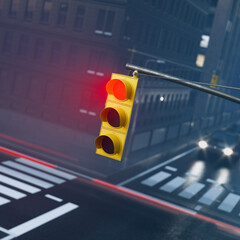 Evening Urban Street Scene with Yellow Traffic Signal and Oncoming Car