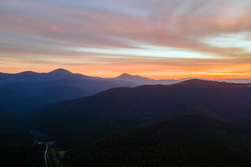 Beautiful mountain panoramic landscape with hazy peaks and foggy valley at sunset