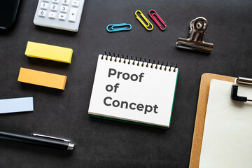 There is notebook with the word Proof of Concept. It is as an eye-catching image.