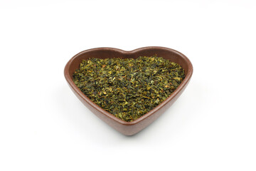 Green tea with herbs in wooden bowl on a White Background.