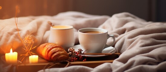 Warm winter morning breakfast with two cups of coffee in bed near festive lights