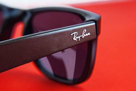 close-up of the Ray-Ban brand logo on black Ray Ban sunglasses with plastic frames.