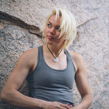 A young blonde woman gearing up for rock climbing on Mount Lemmon, Tucson, Arizona
