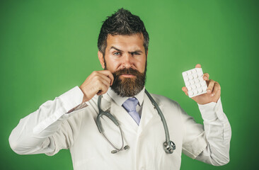 Professional male doctor with pills in in blister pack. Pharmaceutical drug prescription concept....