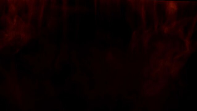 Abstract intense red smoke waves moving on black background across the frame.