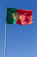 Portuguese flag on a blue sky background
