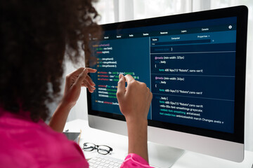 African American woman's programing developer. Coding Software project on computer screen server at...