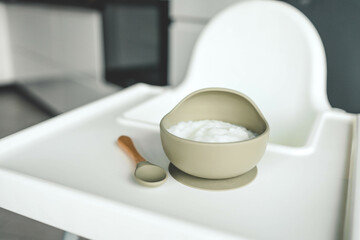 Rice porridge for children in a plate. Feeding children healthy porridge