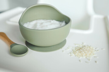 Rice porridge for children in a plate. Feeding children healthy porridge