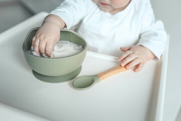 Baby eats rice porridge, complementary foods