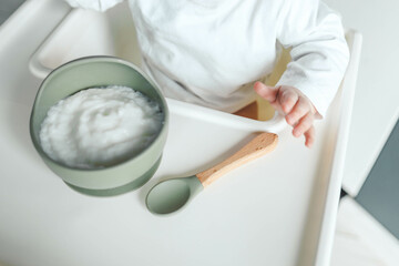 Baby eats rice porridge, complementary foods