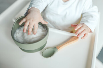 Baby eats rice porridge, complementary foods