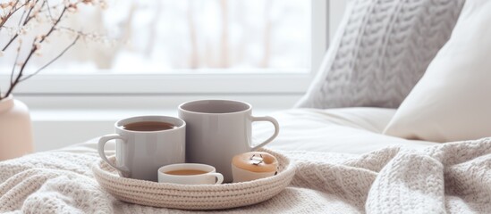Coffee cups placed on a tray in a cozy Scandinavian style bedroom with white gray and beige interior