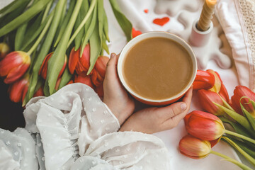 A cup of coffee in the hands of a girl, good spring morning