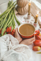A cup of coffee in the hands of a girl, good spring morning