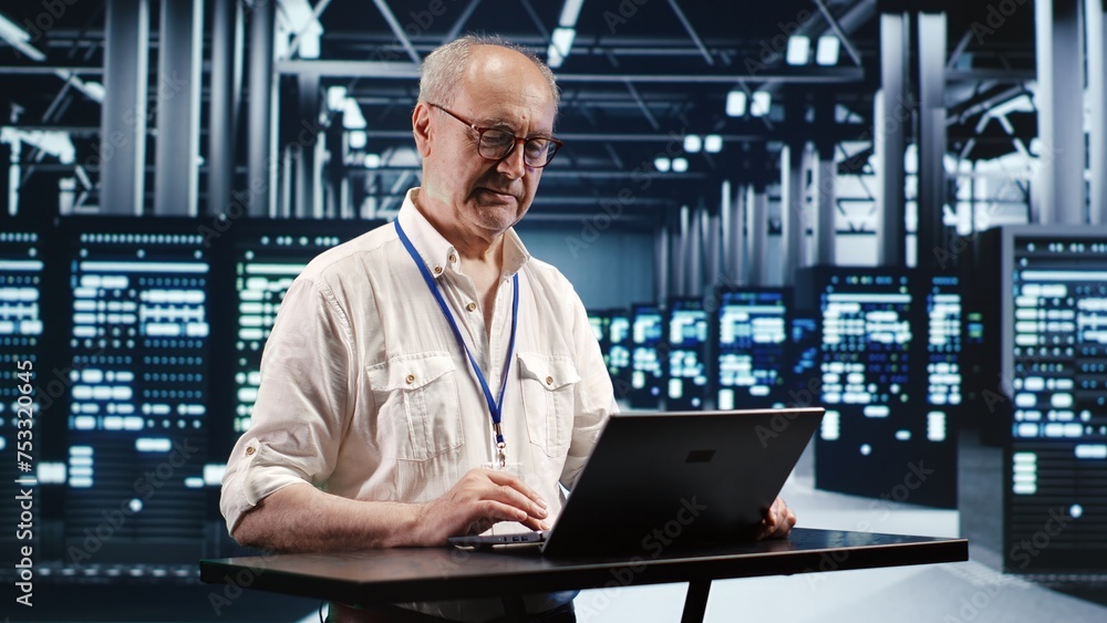 Poster skilled it professional expertly managing data while navigating in industrial server room. expert en