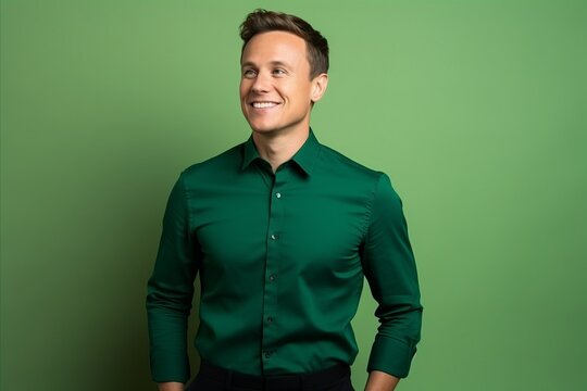 Portrait of a handsome man in a green shirt on a green background
