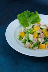 Asian Chicken Salad served on a white plate, social media post, food photography, fine dining, blue background, restaurant menu, Healthy, lifestyle, diet, vegan