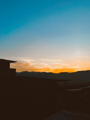 Beautiful sunset with orange sky and huge cloud seen from the Manrique neighborhood. Medellin, Antioquia, Colombia.