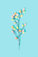 Pattern composition made of pastel color eggs on branches. Flat lay. Top view. Minimal idea of Easter.