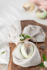 Stylish Easter brunch table setting with egg in easter bunny napkin.