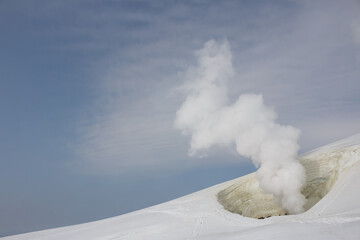 Steam cloud rising from active volcano fumarole vent snow winter landscape, Daisetsuzan, Japan © Alexandra Scotcher