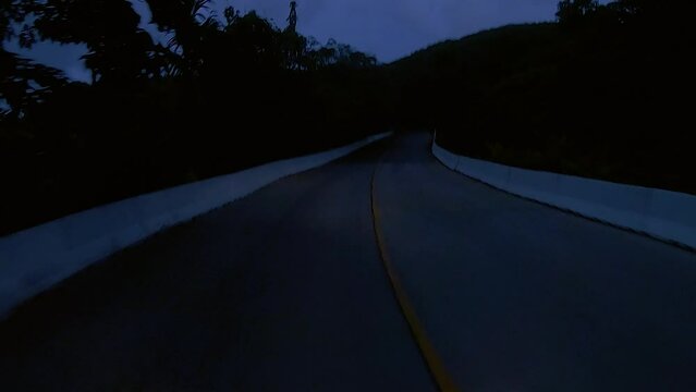 January 12, 2024 - Chalong, Phuket Thailand. Driving at night through dimly lit rural areas outside the tourist areas of Phuket.
