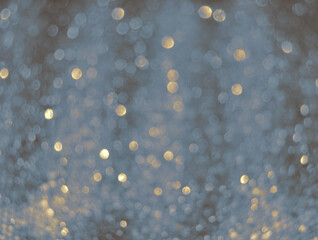 Gray de focused sparkle glitter background with golden particles close up	