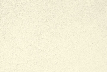 Light yellow plastered wall texture, light yellow rough dry wall texture as background
