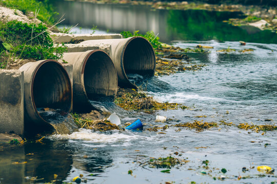 Environmental damage concept, Industrial and factory wastewater discharge pipe into the canal and sea, dirty water pollution, Sewage pipe outfall into the river, the river is polluted