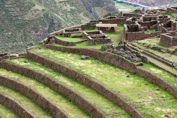 The Pisac Ruins are an archaeological site located in the Sacred Valley of Peru,. These ruins are part of the larger Inca Empire and are known for their impressive agricultural terraces. - obrazy, fototapety, plakaty
