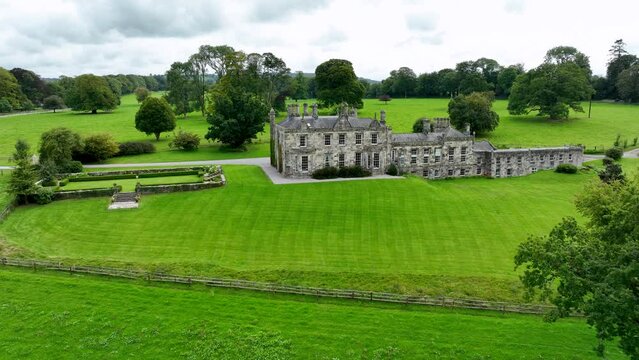 An old manor house with green lawns in the background in 4k