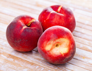 Naklejka na ściany i meble Closeup of whole ripe red peaches on wooden table. Vitamin fruits