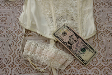 white lingerie and a five dollar bill