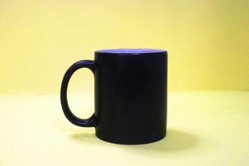 Black mug On The Yellow Background