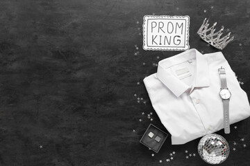 Male shirt with crown, wrist watch and text PROM KING on black grunge background