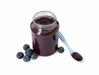 Jar of healthy baby food, fresh blueberries and spoon isolated on white