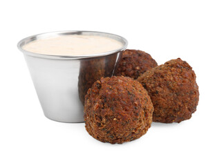 Delicious falafel balls and sauce isolated on white