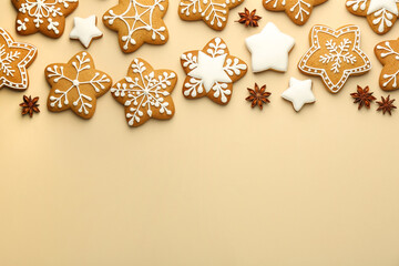 Tasty Christmas cookies with icing and anise stars on beige background, flat lay. Space for text