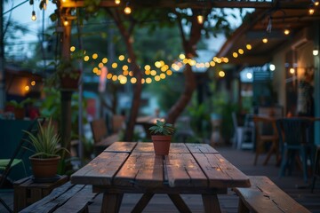 Outdoor cafe scene with a wooden table and atmospheric lighting Creating a cozy and inviting space for dining and socializing - obrazy, fototapety, plakaty