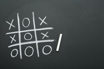 Tic tac toe game drawn on chalkboard, top view