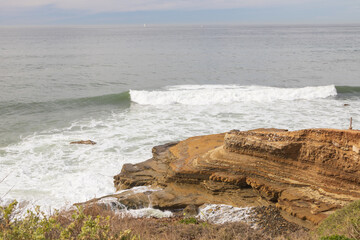 Waves breaking and cliffs on the west coast, San Diego, California