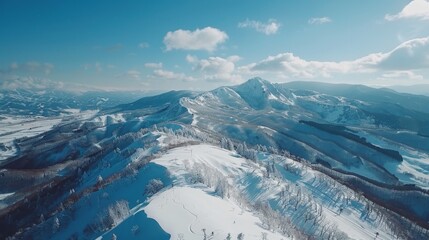 An aerial perspective reveals a snow-covered mountain range in striking detail
