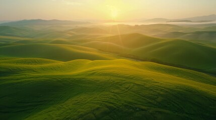 Fototapeta premium Drone perspective of a serene countryside sunrise, with mist hovering over rolling hills
