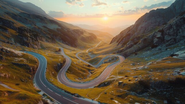 Through a dramatic mountain pass, an aerial perspective captures the winding road snaking its way through the landscape
