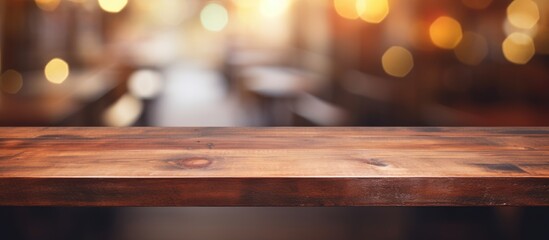 Wooden table with blurred abstract background for product display in restaurant or cafe