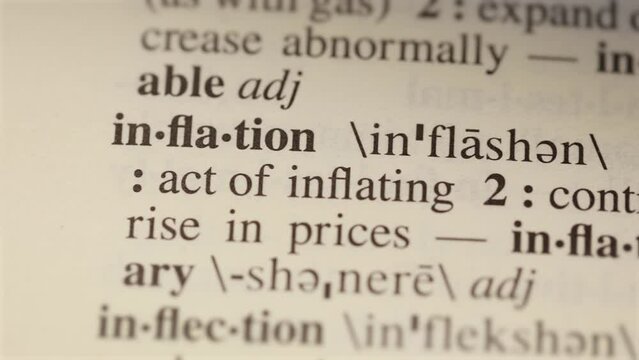 inflation word on dictionary page reading letters